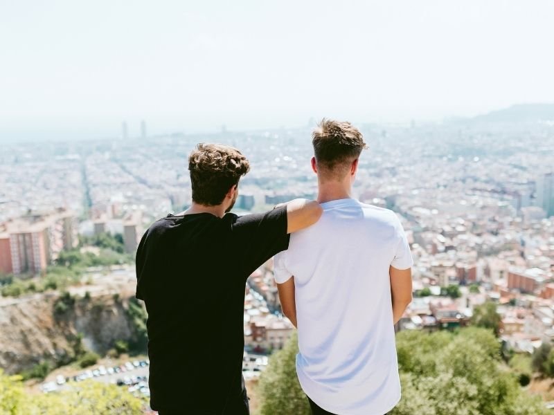 Young professional working on a laptop at night, managing a side hustle.