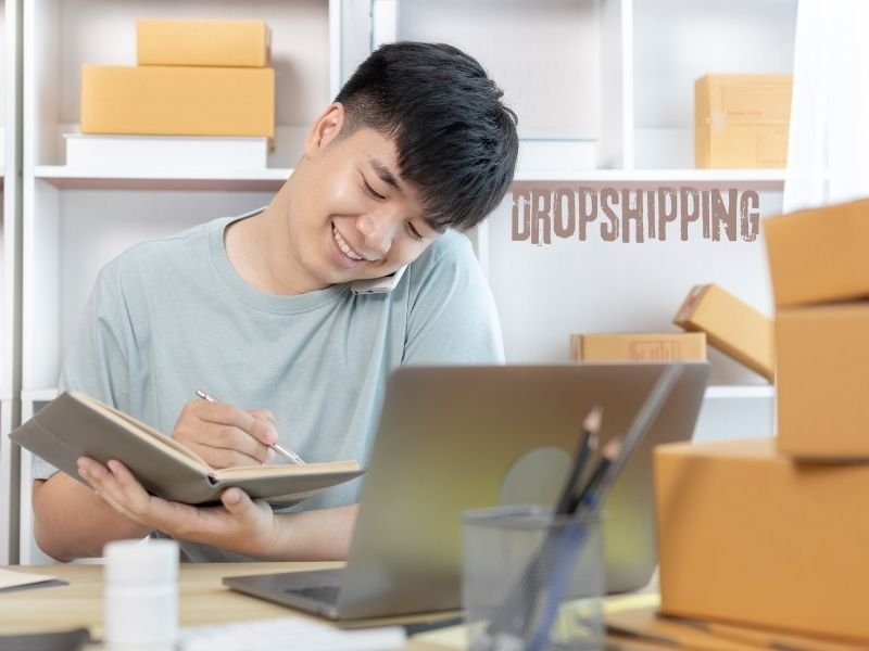 Laptop screen showing online dropshipping store setup.